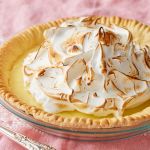 A lemon meringue pie with golden crust, smooth curd, and pillowy meringue topping that's toasted.