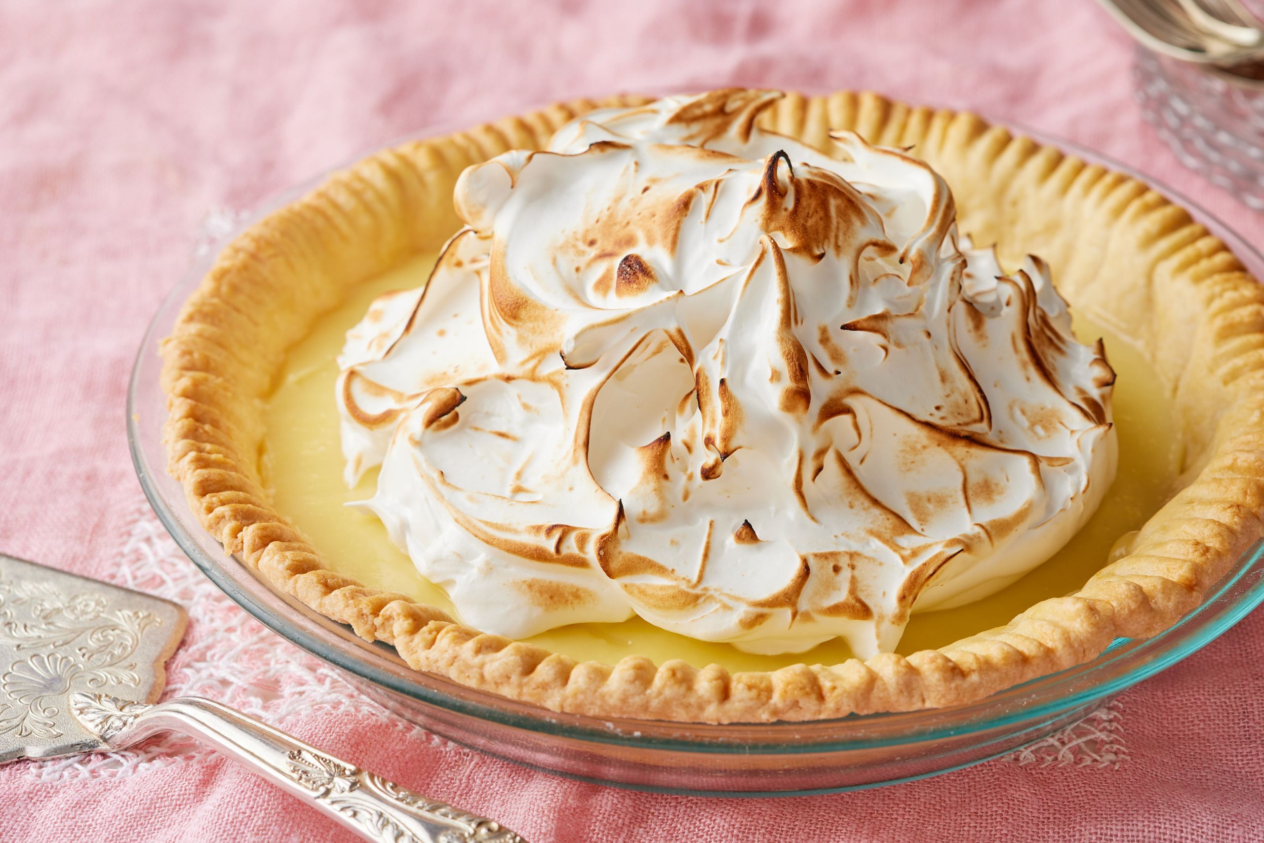 A lemon meringue pie with golden crust, smooth curd, and pillowy meringue topping that's toasted.