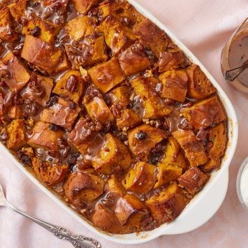 Horizontal top down view of pumpkin bread pudding drizzled with praline sauce.
