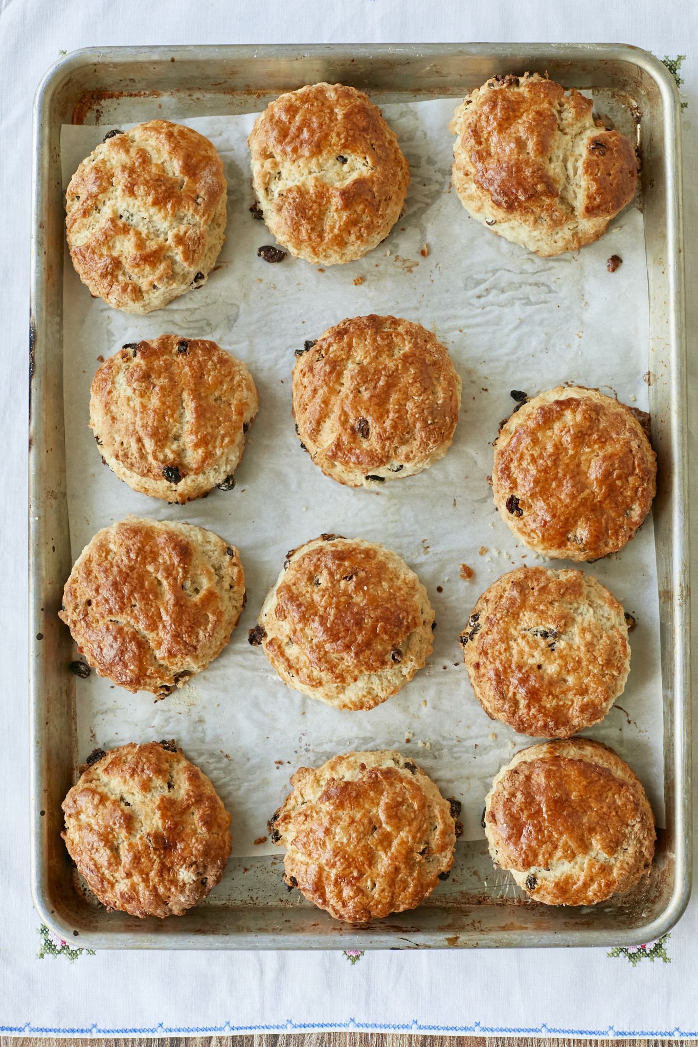 A baking tray of golden brown baked scones. 