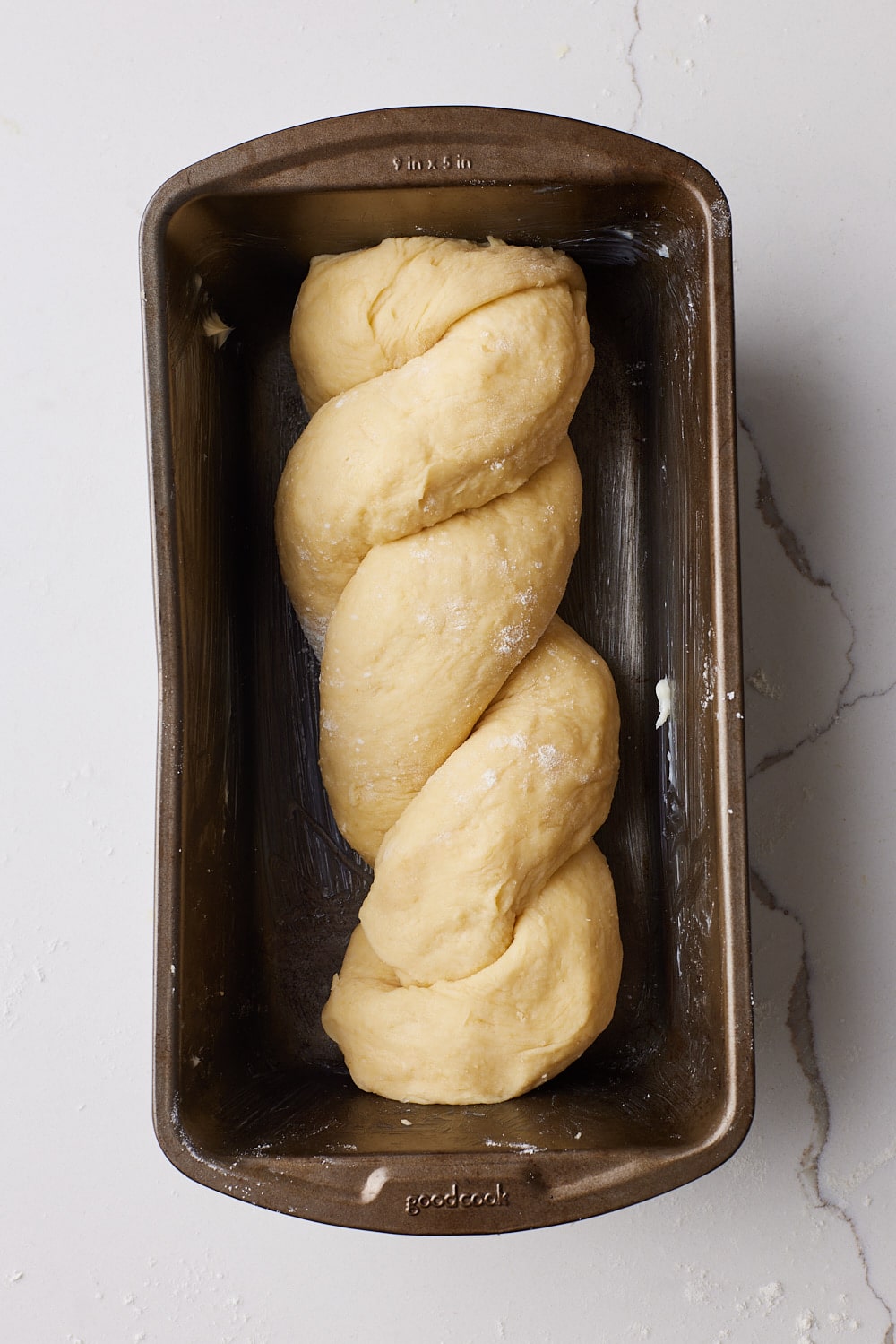 Proof the braided dough in the prepared loaf pan. 