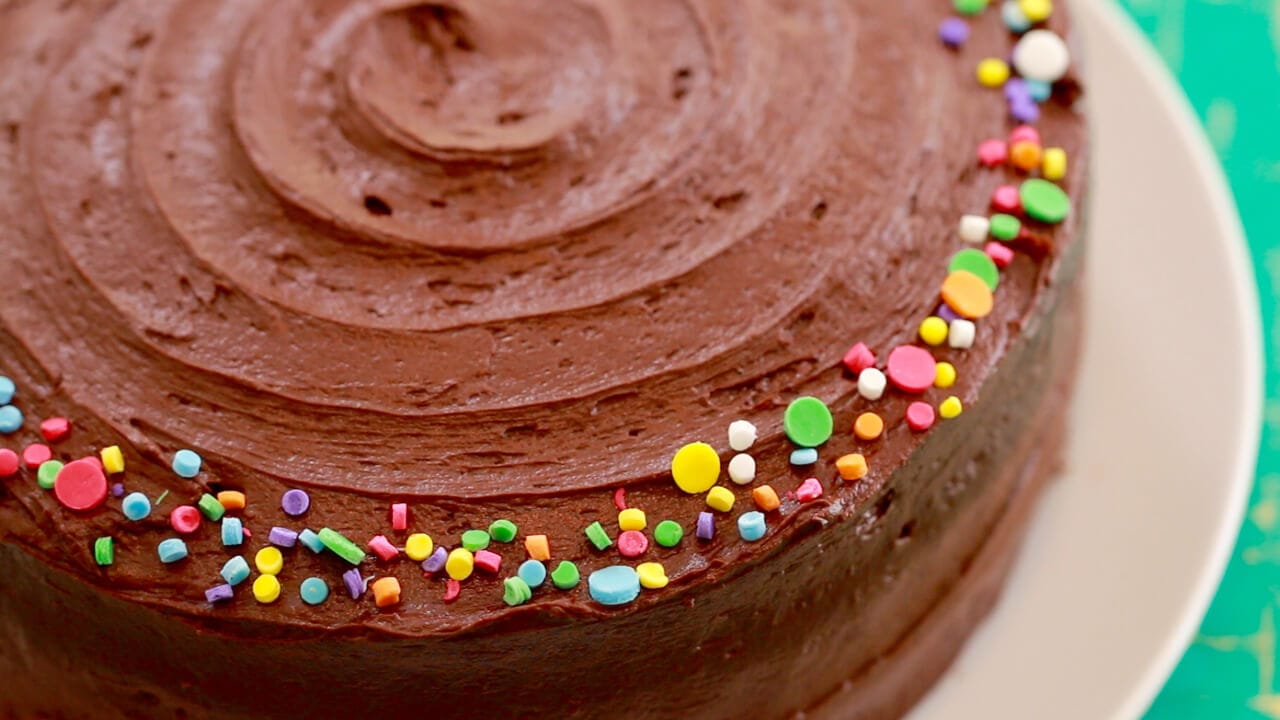 Top-down view of my Classic Chocolate Cake recipe, showing sprinkles, fudge frosting, and texture.