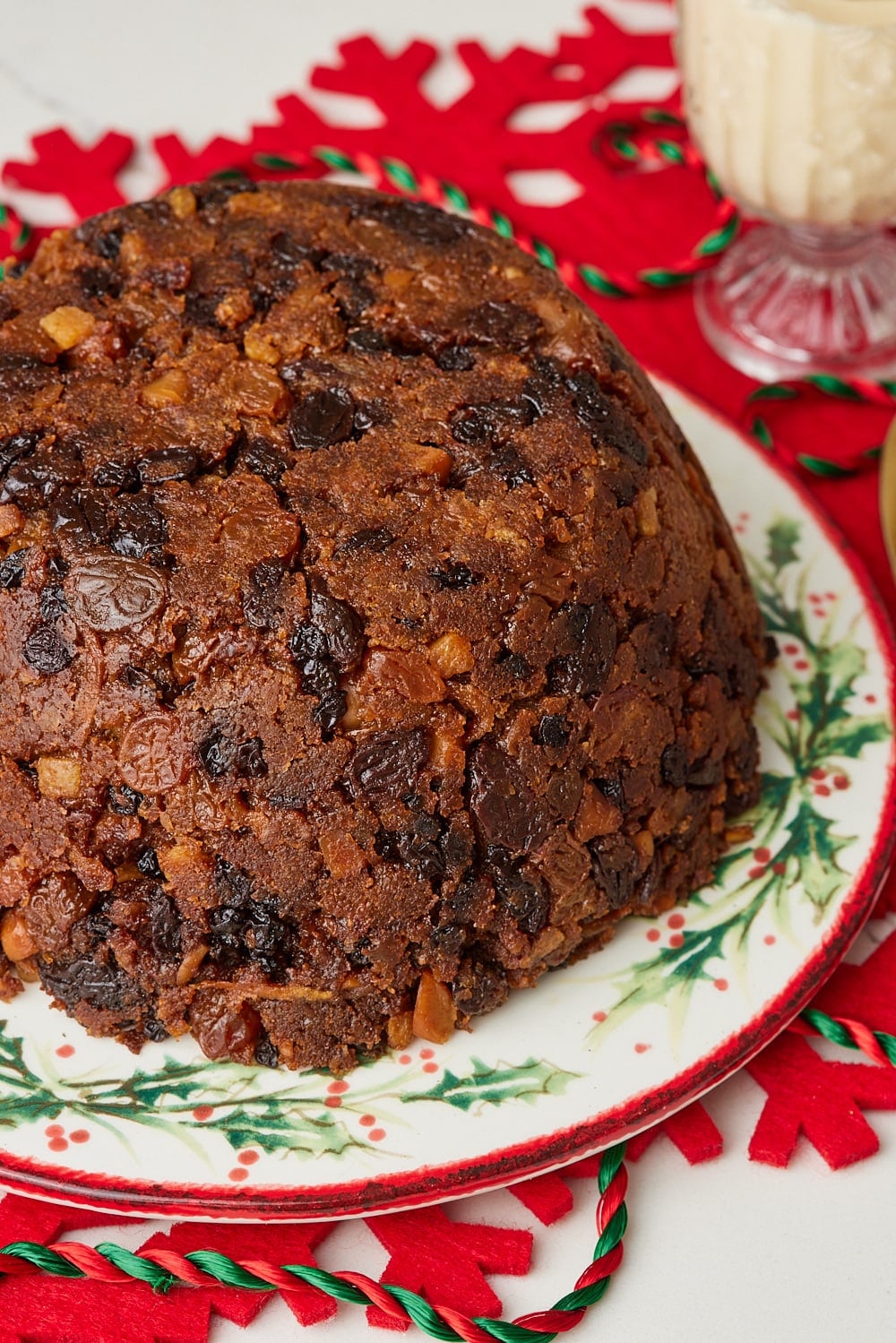 Christmas Pudding10 Traditional Irish Christmas pudding packed with raisins, currants, sultanas, candied peel, and almonds, served on a festive Christmas plate.