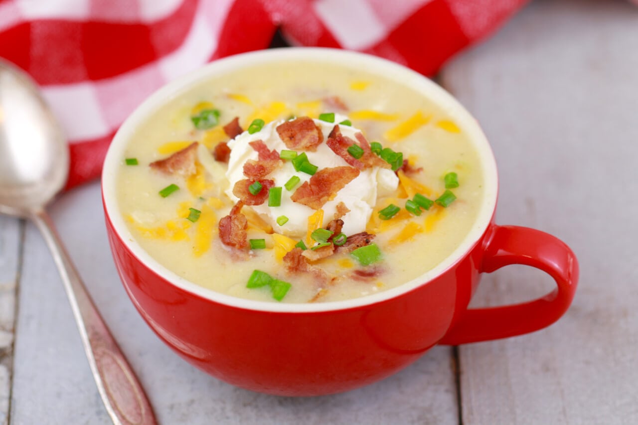 Microwave Loaded Baked Potato Soup In A Mug; Imagine a baked potato with all the trimming: bacon, cheese, sour cream. Now imagine that as a delicious, creamy soup made in the microwave from start to finish in MINUTES! A delicious soup that is guaranteed to warm you cockles and fill you up until dinner.