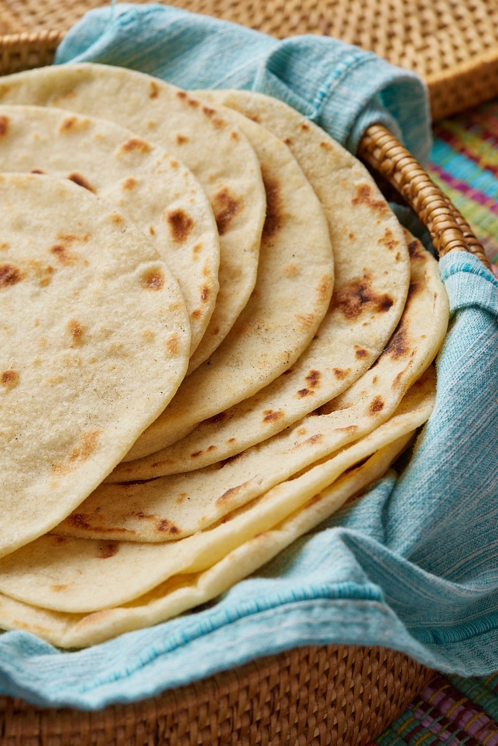 A close shot at a stack of homemade flour tortilla with bulles. 