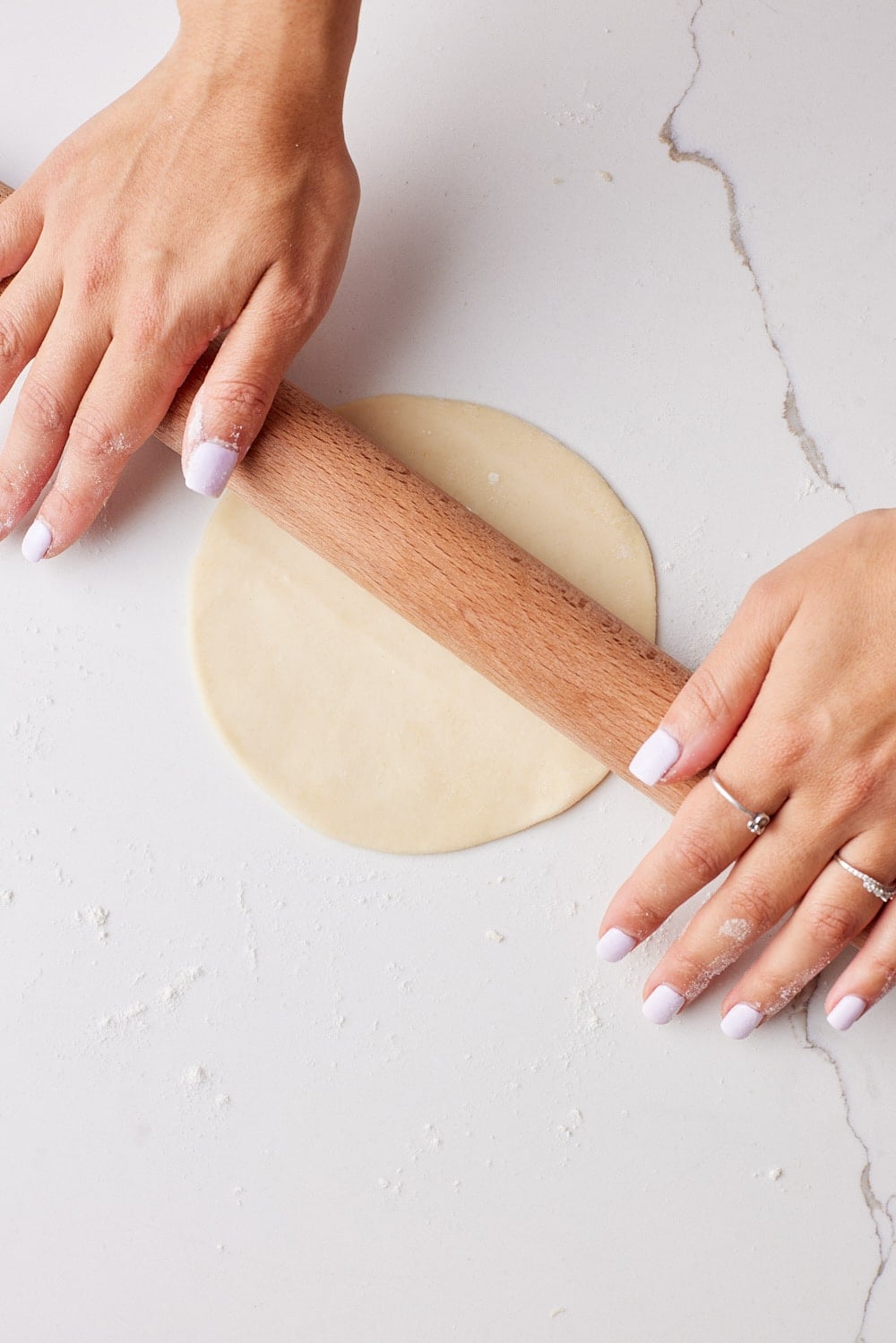 Flatten each homemade flour tortilla dough using a rolling pin. 