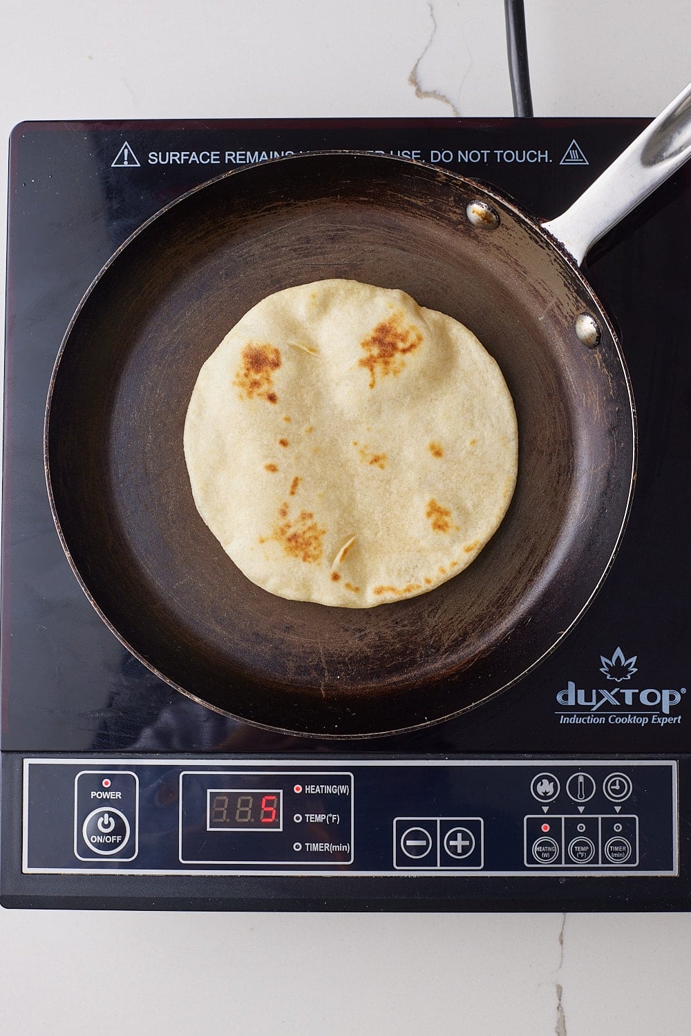 Cook second side: Flip and cook for 30 seconds more. The tortillas should remain soft with little brown spots. Avoid overcooking to prevent crispiness.