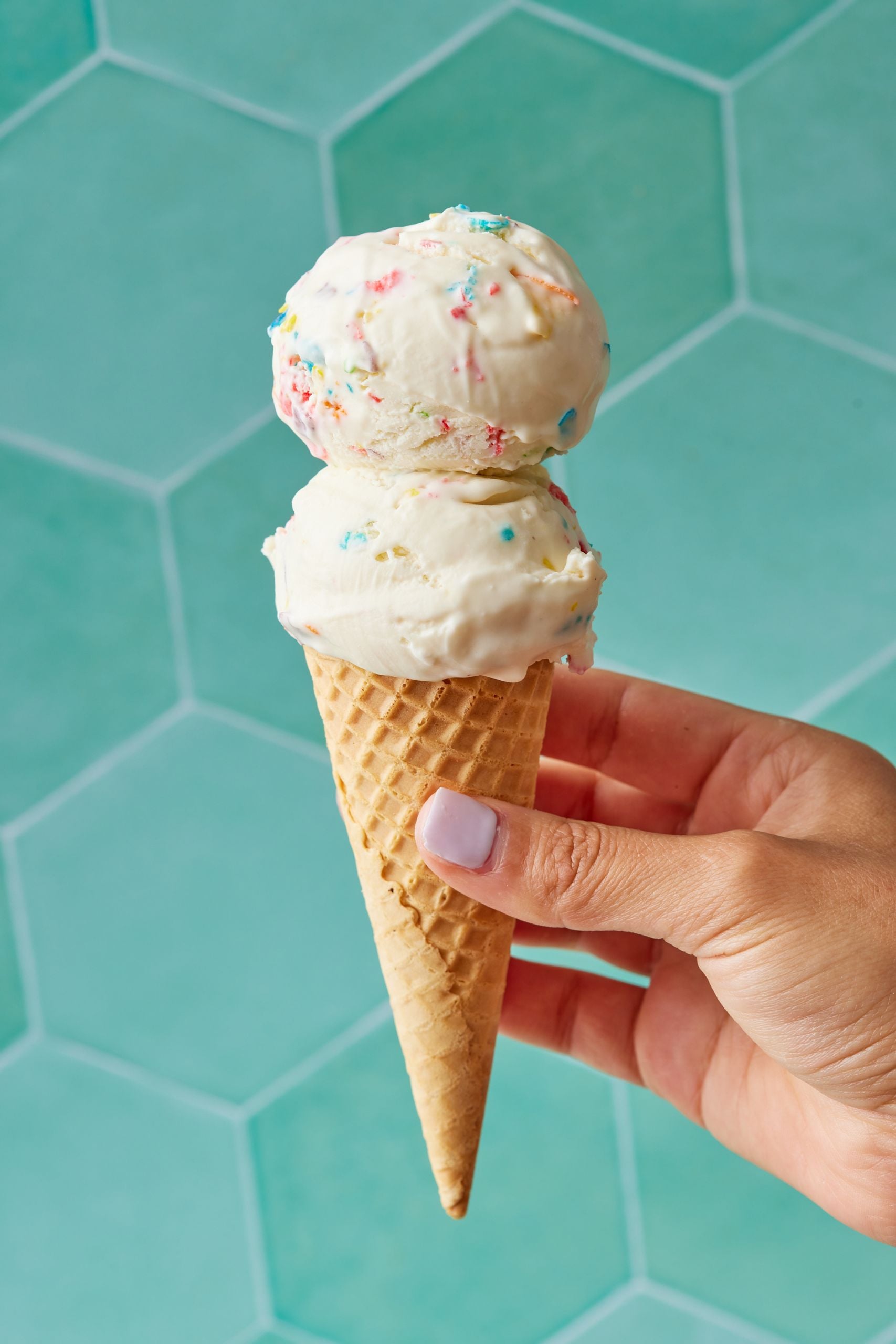 Two scoops of Cereal Milk Ice Cream is served in an ice cream cone
