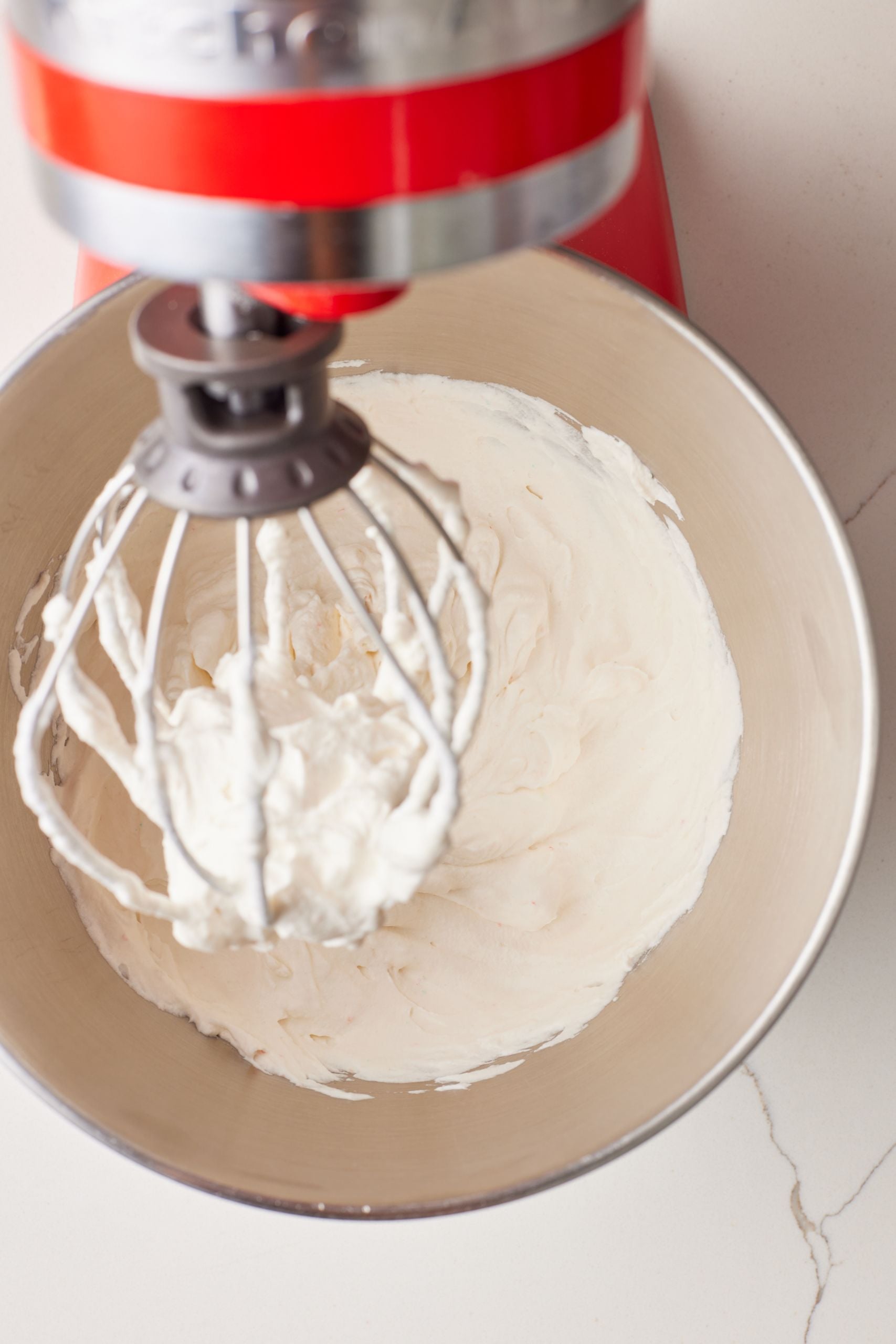 Whip up heavy whipping cream in a stand mixer until soft peaks form