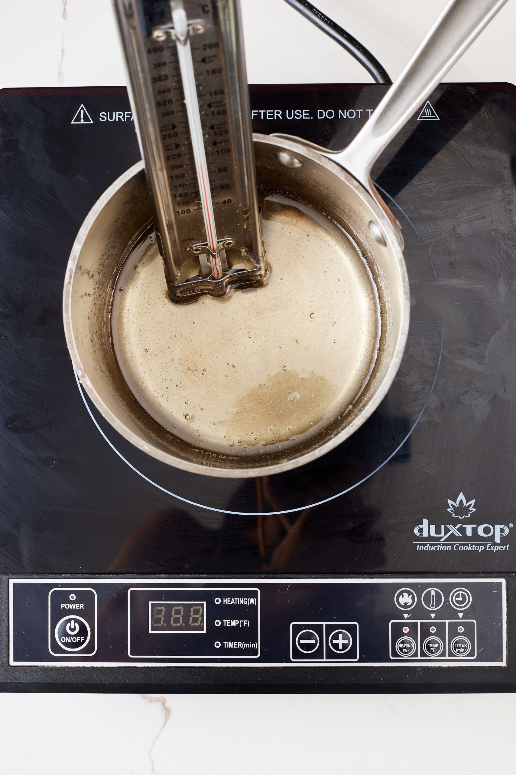 Heat the sugar, corn syrup and water mixture , put the candy thermometer in. 