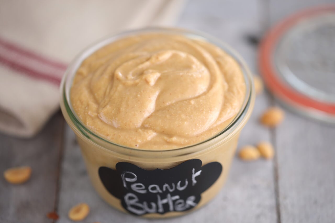 A jar filled with homemade peanut butter.