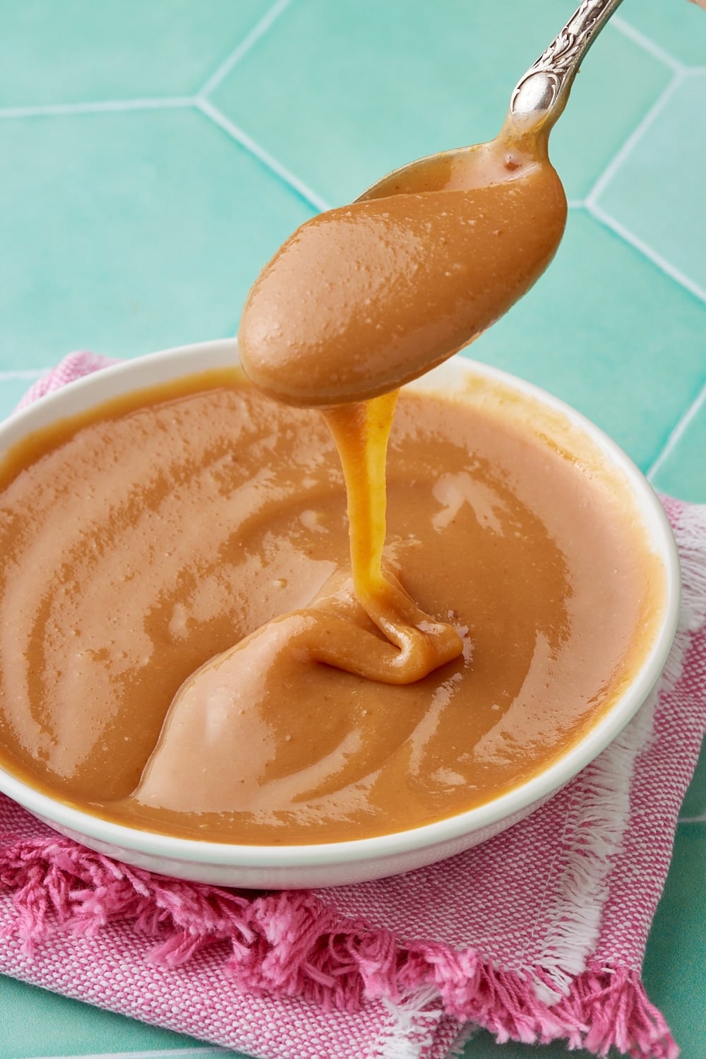 Dulce De Leche6 A bowl of dulce de leche with a spoonful over it.