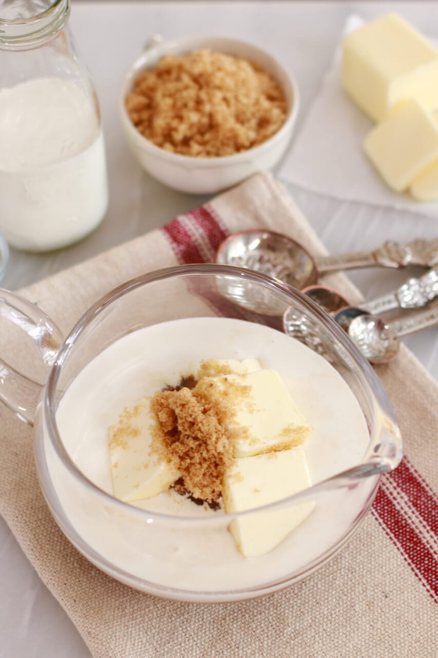 A bowl with caramel sauce ingredients ready for microwaving.