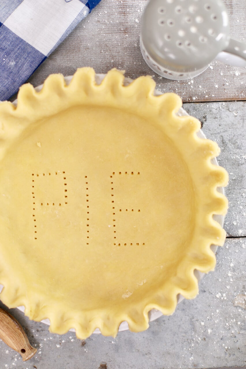 My Homemade Pie Crust, before baking, with the word "PIE" poked into it.