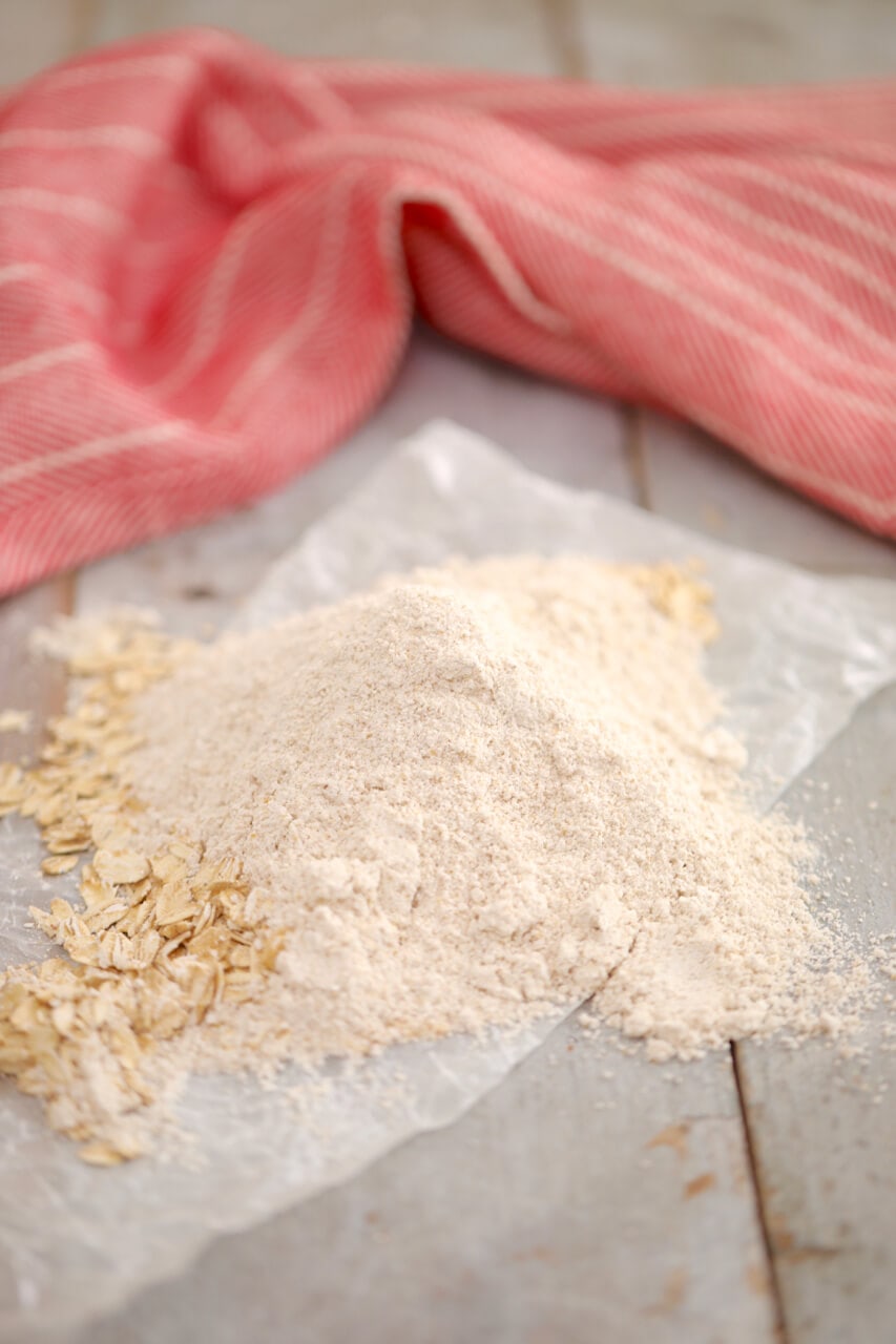 A pile of oat flour on parchment.