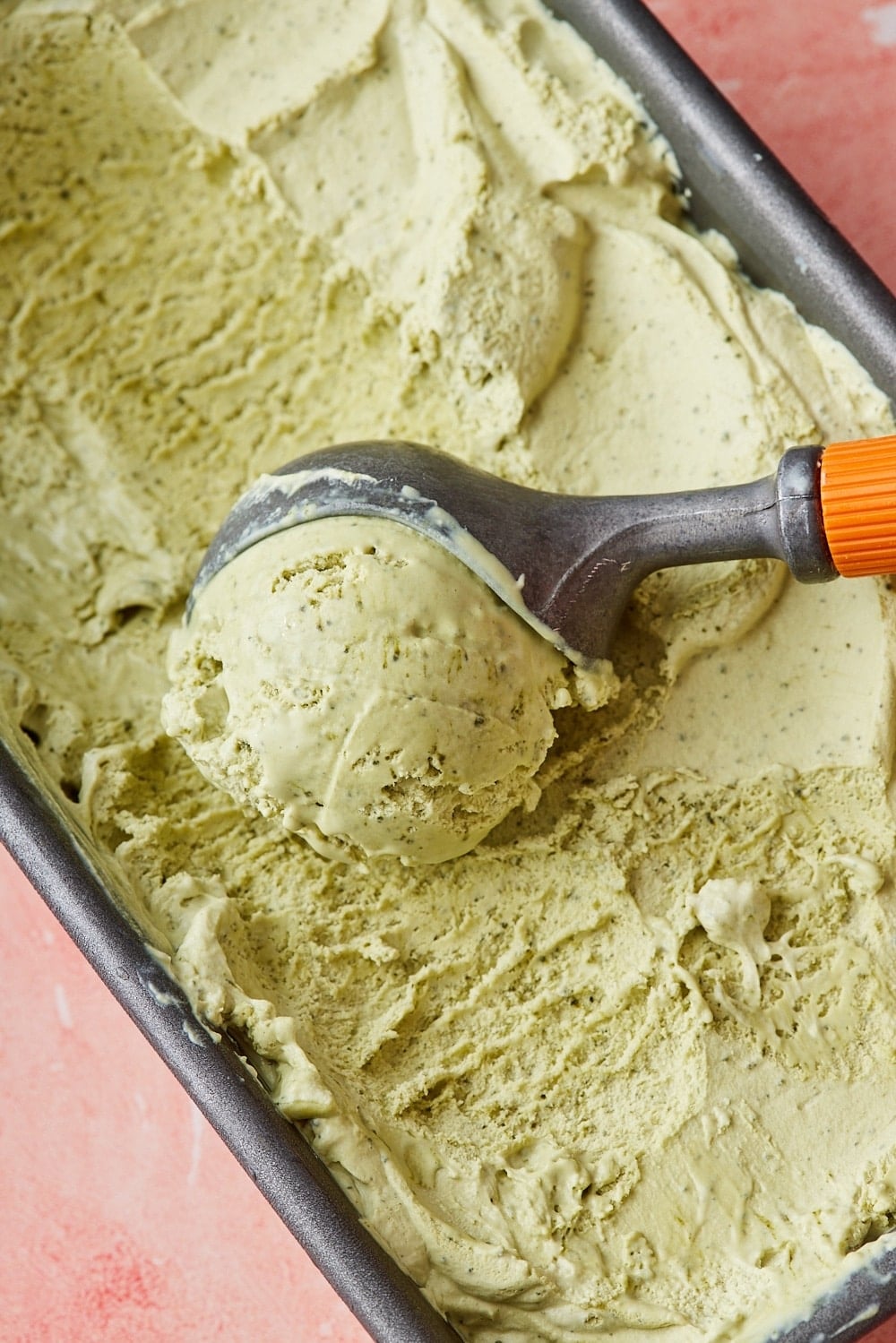 Green tea ice-cream6 Green Tea Ice Cream in a loaf tin with a scoop of it in the center.
