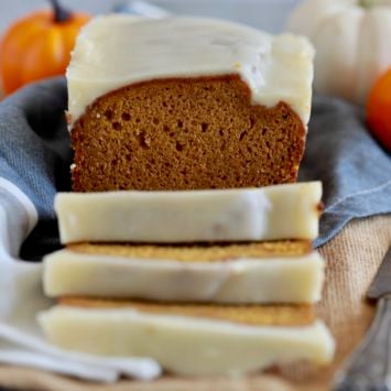 This is the Best Ever Pumpkin Bread recipe, with pumpkins in the background.