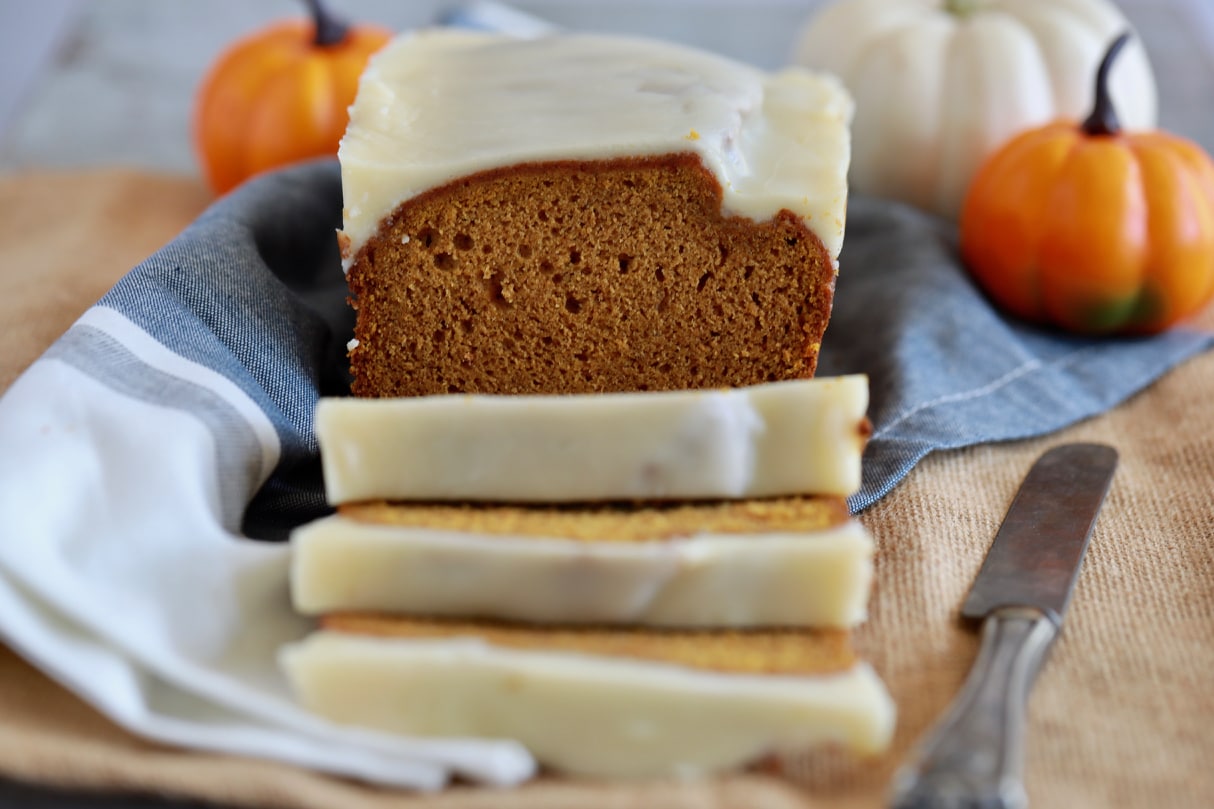This is the Best Ever Pumpkin Bread recipe, with pumpkins in the background.