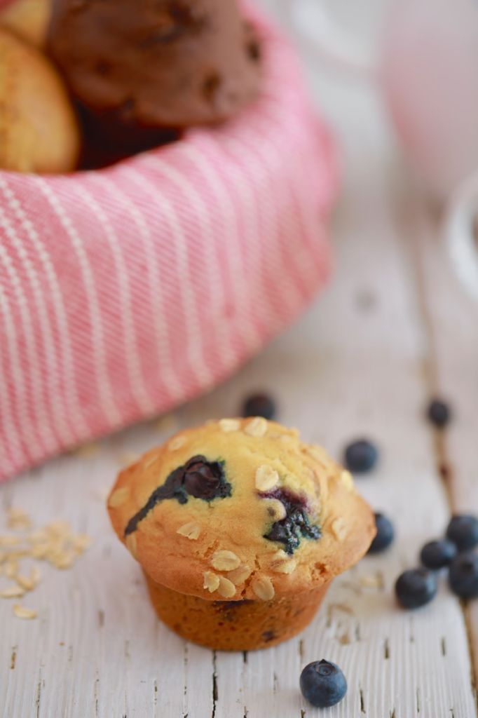 A blueberry oat muffin, next to some blueberry.