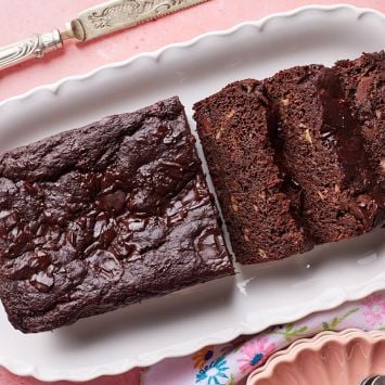 Half loaf of Healthy Chocolate Banana Bread with three slices on a platter.