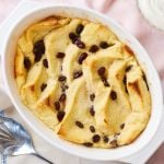 Bread and Butter Pudding in a baking dish with golden and slightly crispy bread and gooey raisins.
