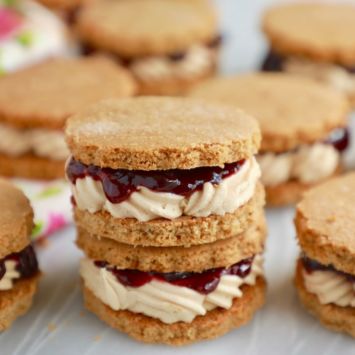 Peanut Butter and Jelly Sandwich Cookies are the perfect marriage of sweet and salty. Soft, crumbly cookie with a soft buttercream and jam center.