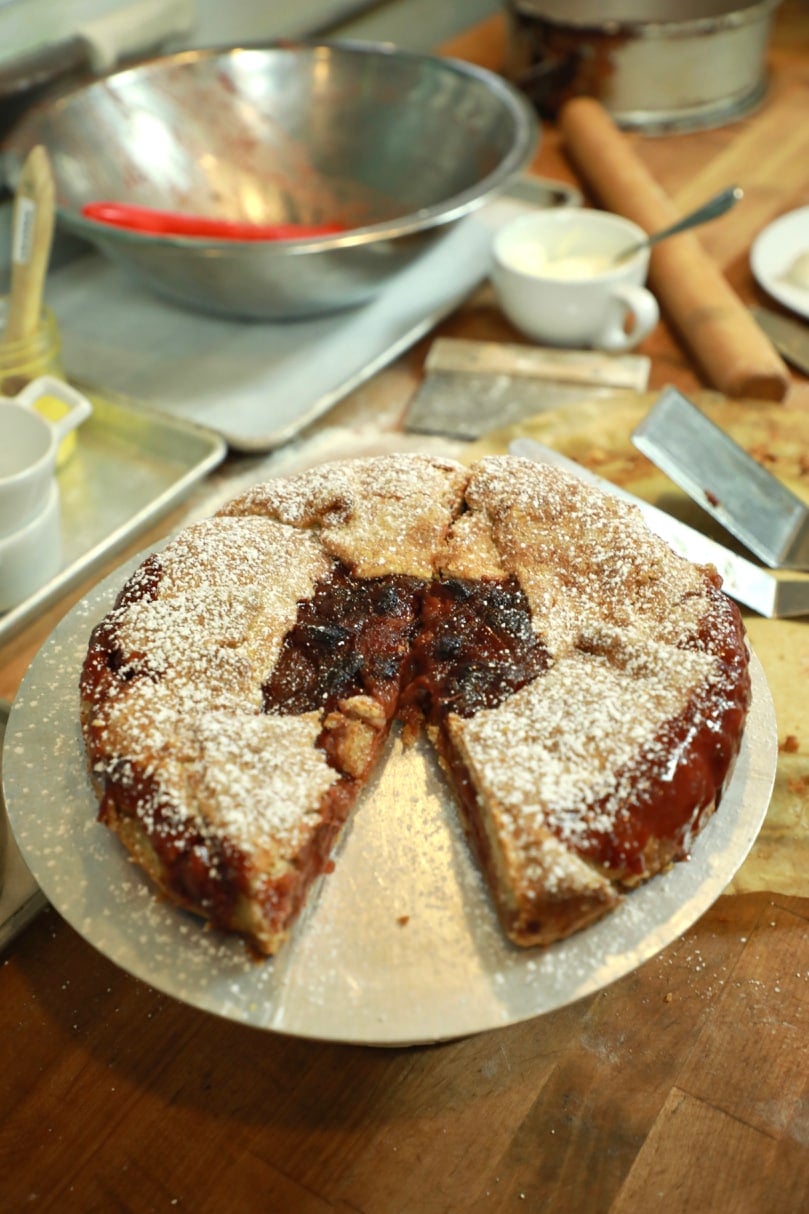 Strawberry & Rhubarb Crostata topped with powdered sugar. 