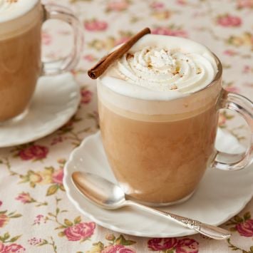 Two cups of Pumpkin Spice Latte with cinnamon .