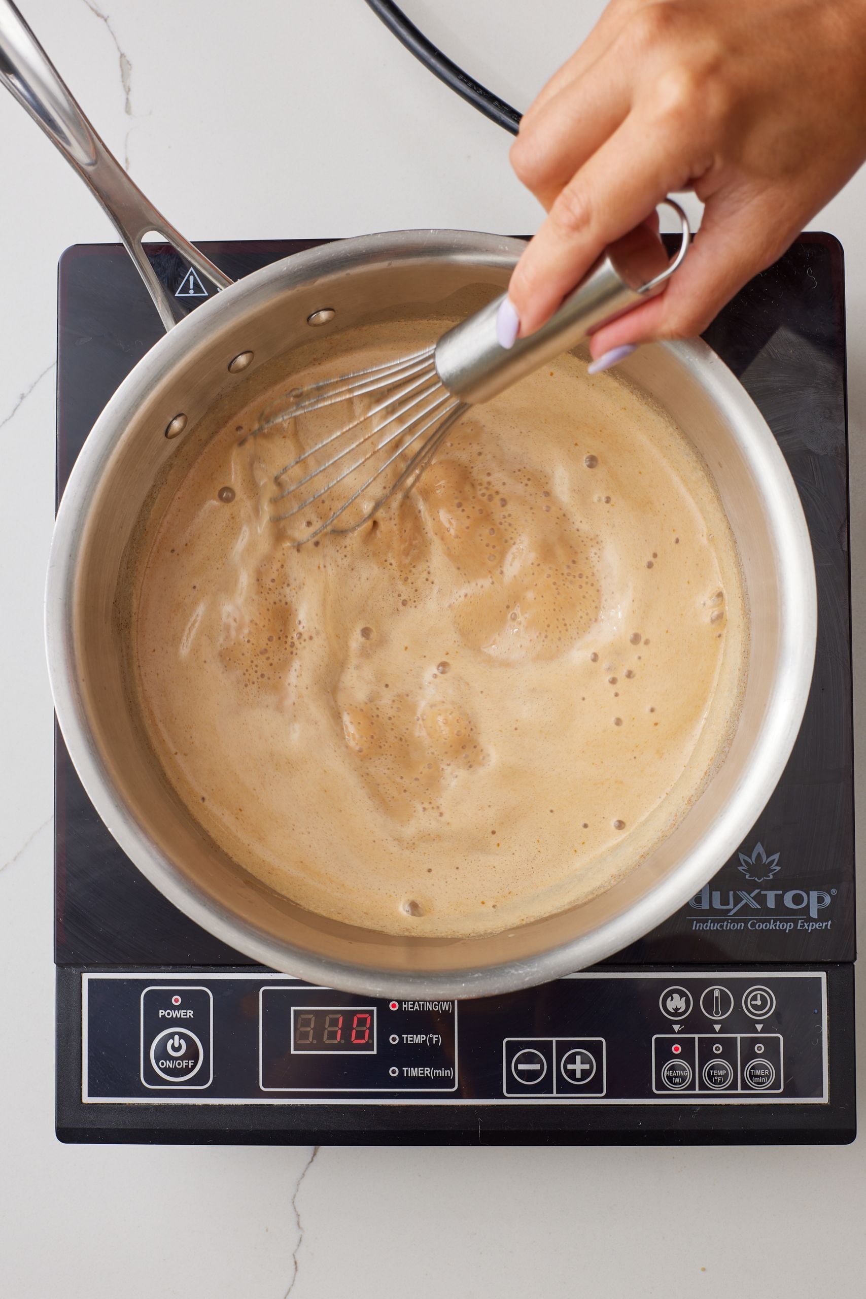 Step-by-step instructions on how to make Pumpkin Spice Latte: : Over medium heat, bring the mixture to a simmer while whisking, about 5 minutes.