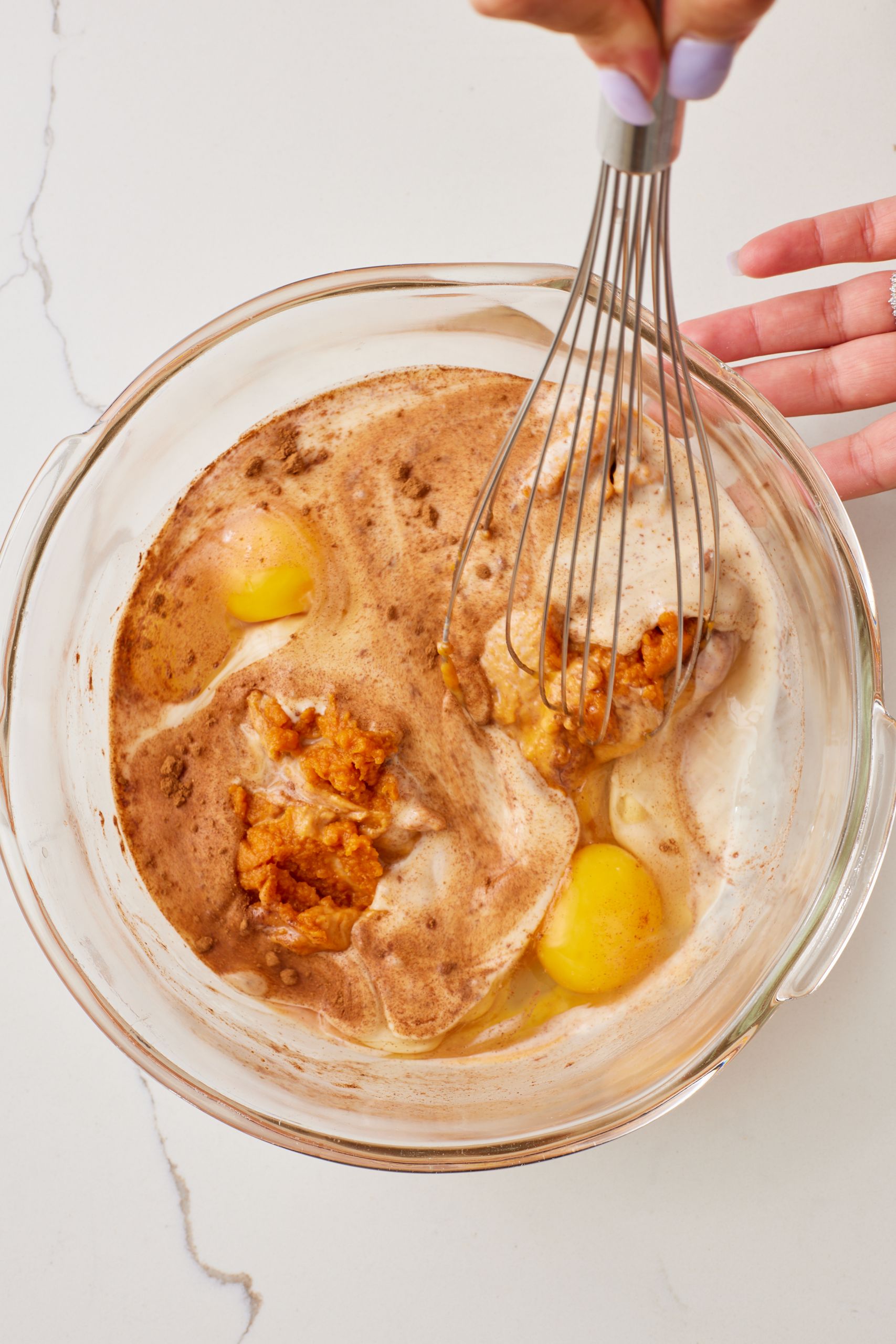 In a large bowl, whisk together pumpkin puree, eggs, evaporated milk, sugar, maple syrup, pumpkin pie spice, and salt until smooth.