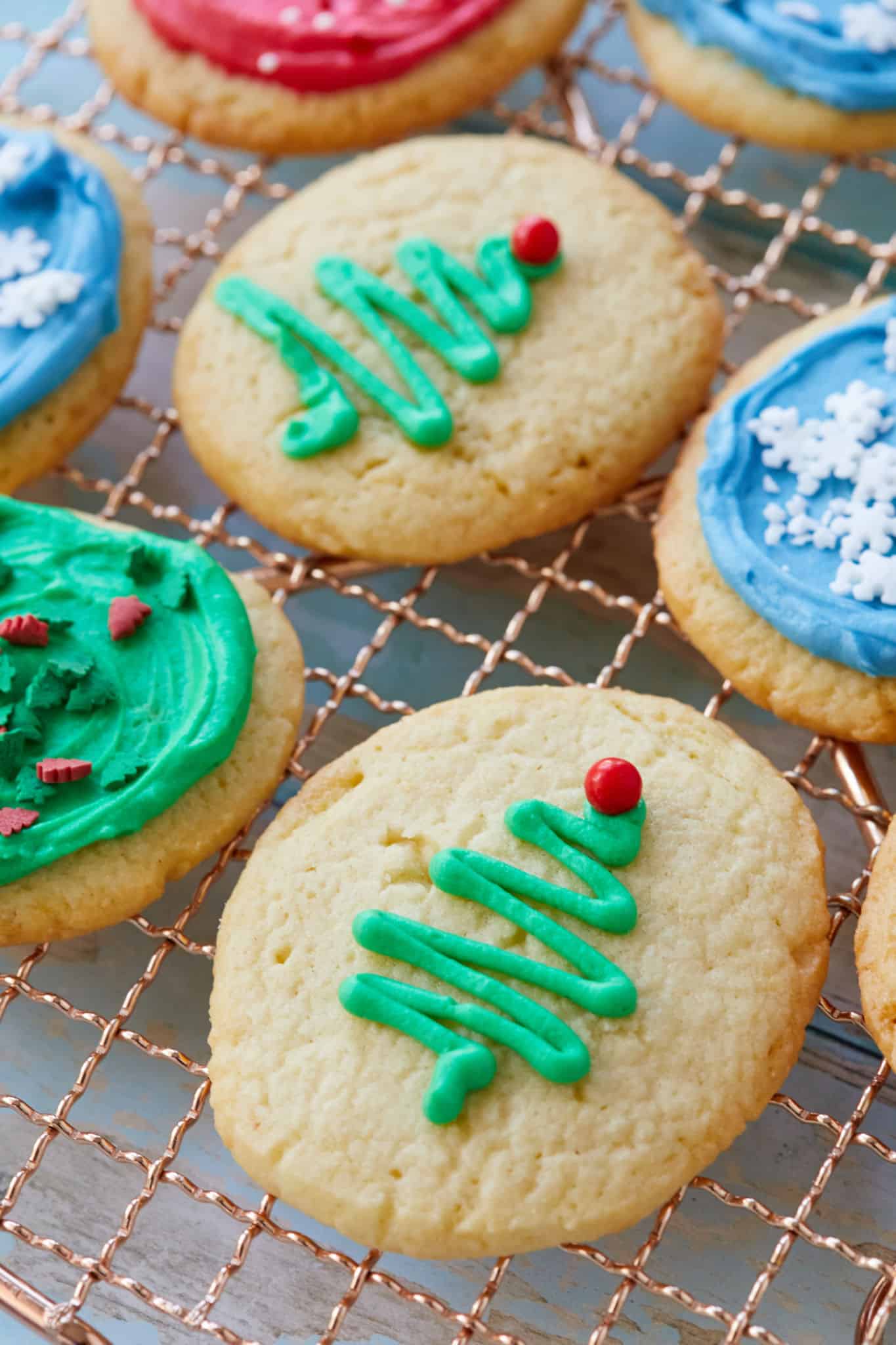 A close up of christmas tree decorations on my soft sugar cookies recipe.