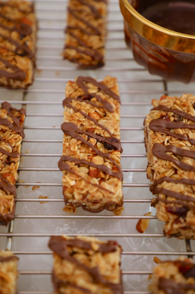 A close up of my homemade granola bars recipe, drizzled with chocolate, and baked to perfection.