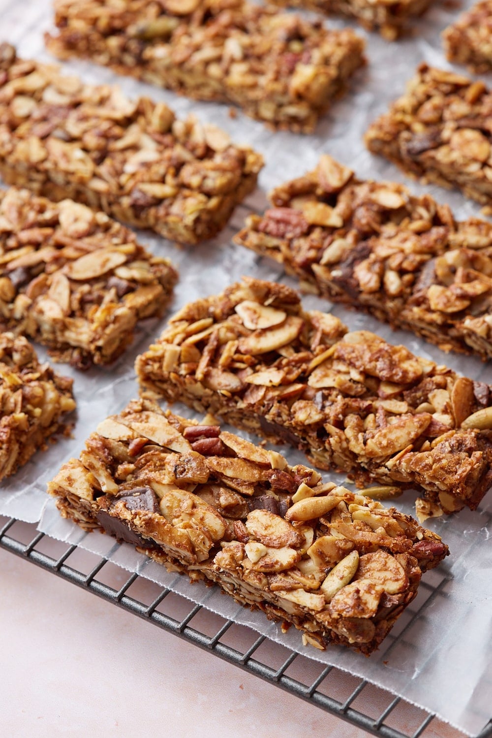Healthy Granola Bars8 Sliced healthy granola bars on a parchment paper lined cooling rack.