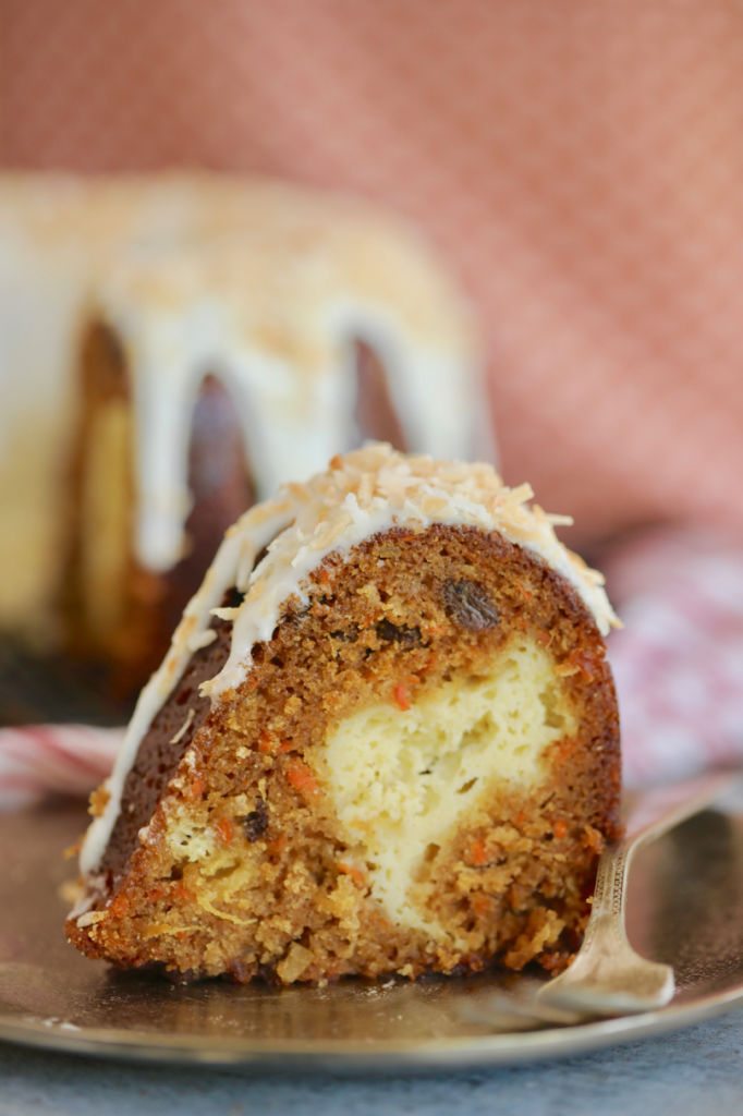 Soft, moist Carrot pound cake is loaded with shredded carrots and raisins. It's decorated with cream cheese glaze and coconut, and stuffed with cream cheese filling.