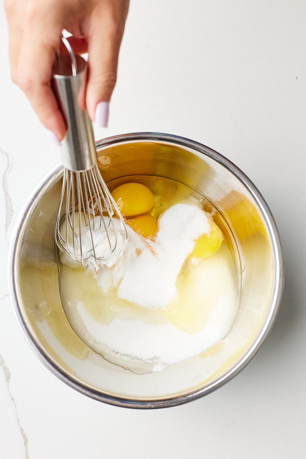 Whisk eggs and sugar together in a bowl for microwave lemon curd. 