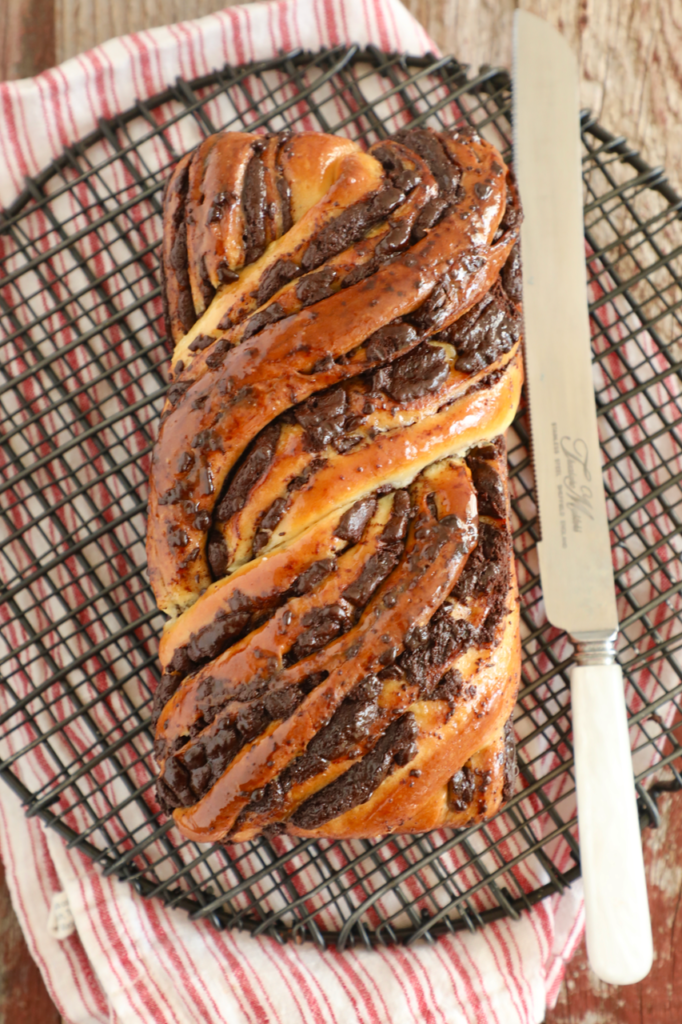 An entire loaf of Chocolate Babka from overhead, swirled with chocolate and ready to cut.