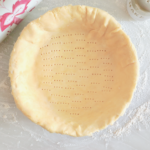 An empty savory pie crust recipe ready to be baked.