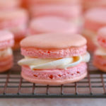 Filled, pink, macarons showing buttercream and texture.
