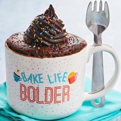 The Best Chocolate MugCake is topped with chocolate buttercream frosting and sprinkles.