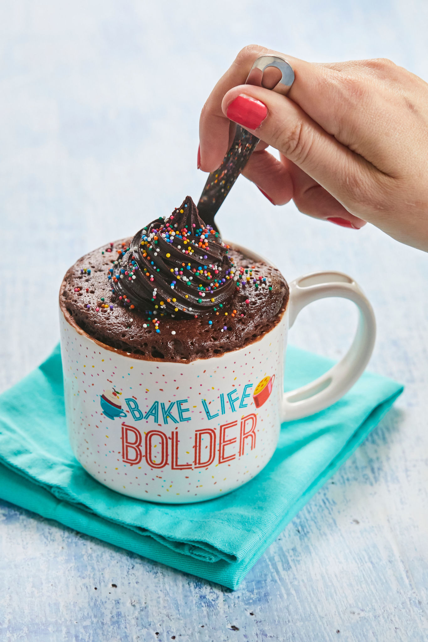 Best-Ever Chocolate Mug Cake is cooked perfectly in a mug, topped with colorful sprinkles. 
