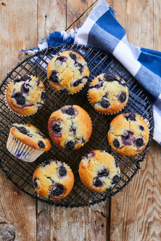 My Lemon Blueberry Muffins recipe resulted in these bakery-style muffins, arranged on a cooling rack.
