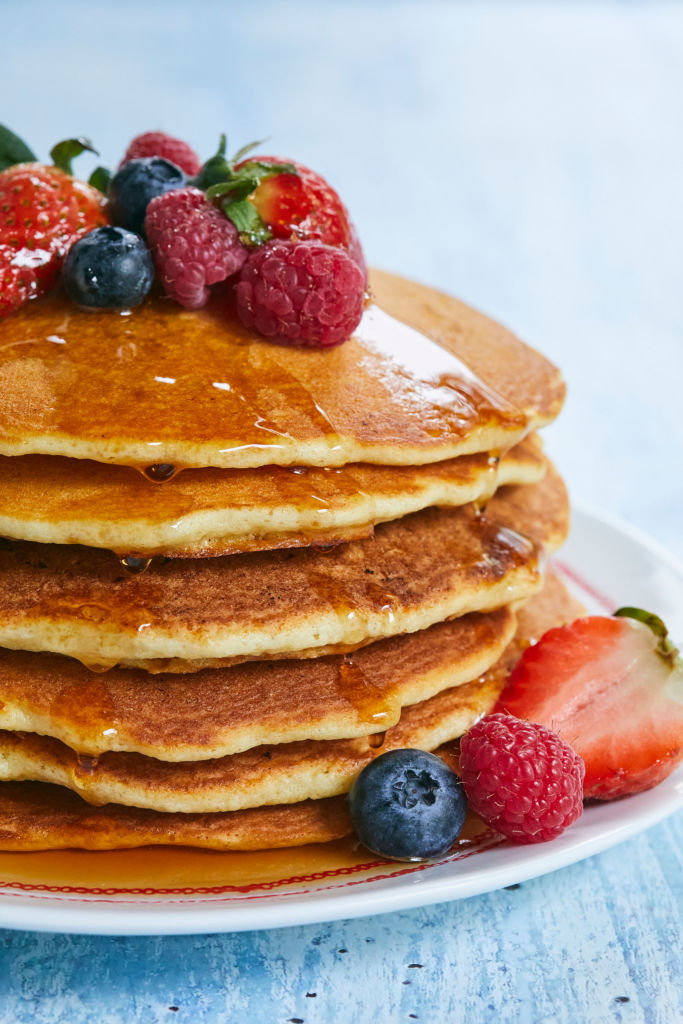 A side-view of Gluten-Free Pancakes with berries.