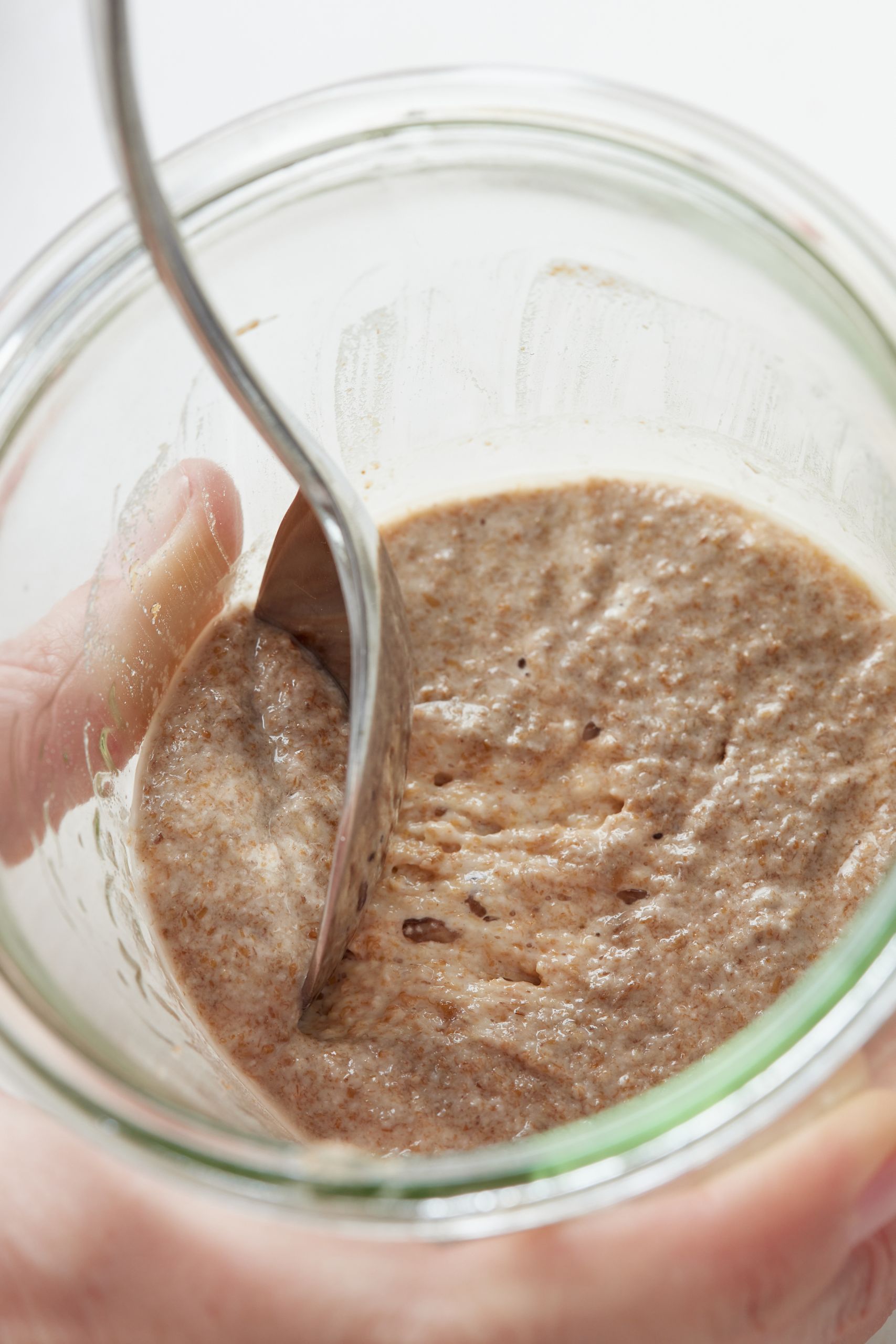 Remove and discard approximately half of your starter from the jar. I did this by eyeballing it each time and its works perfectly.