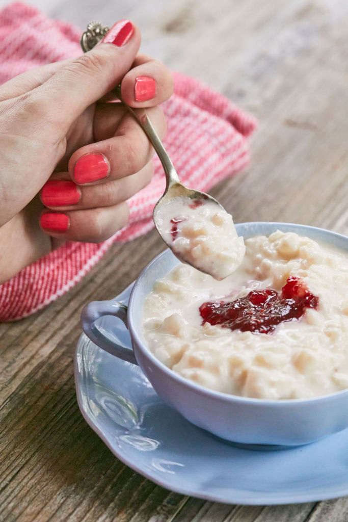 A close up of The Creamiest Rice Pudding Recipe, on a spoon, to show texture and consistency.