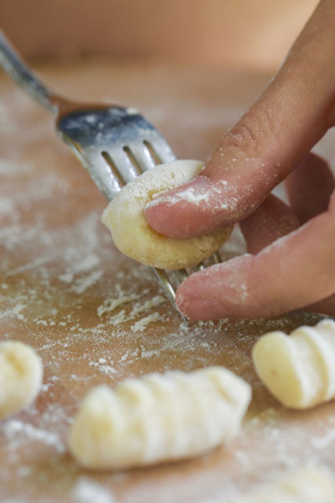 Shaping 3-Ingredient Homemade Gnocchi with a fork.