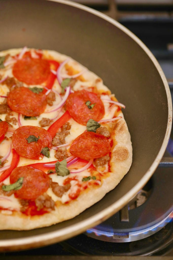 A finished Stovetop Pizza recipe after being cooked in a skillet.