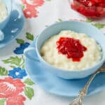 two bowls of rice pudding is served with Raspberry jm
