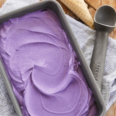 Homemade 3-Ingredient Ube Ice Cream is thick and smooth, in a vibrant purple color.