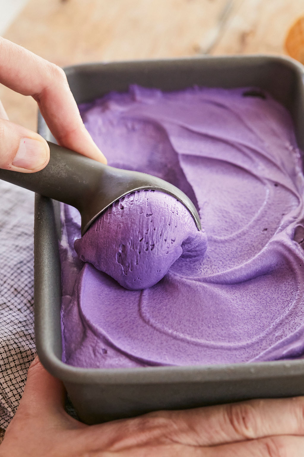 A close up scoop of purple Ube Ice Cream to show texture, color, and how easy it is to scoop.
