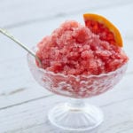 My Blood Orange Granita filled to the top of a glass bowl is a refreshing frozen dessert.